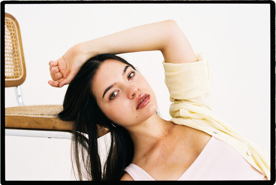 Woman posing on chair in studio portrait