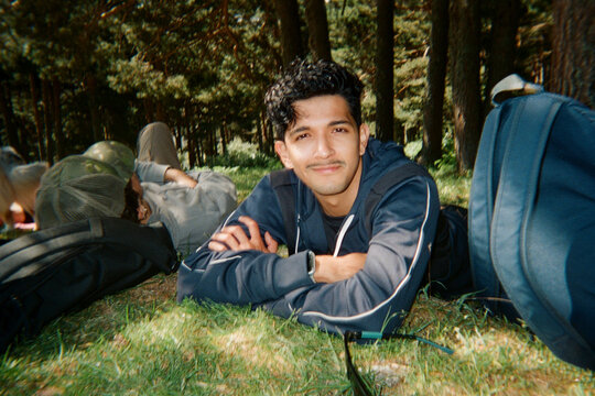 Title: Man Resting in Pine Forest with Backpack