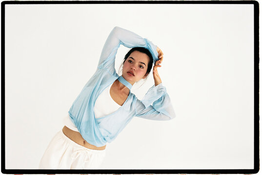 Woman posing in blue top 