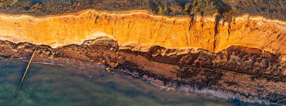Golden morning light on eroded cliffs along a rugged coastline