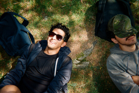 Two Men Resting on Forest Ground