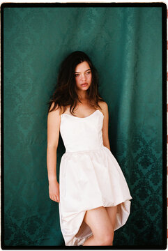 Young woman posing in elegant white dress