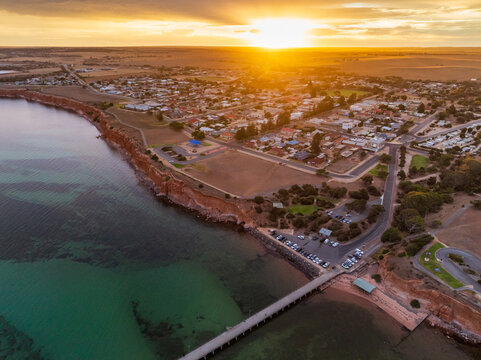 Golden sunset over a coastal town high on cliff tops above the sea
