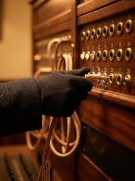 Hand operating vintage telephone switchboard with cable plug