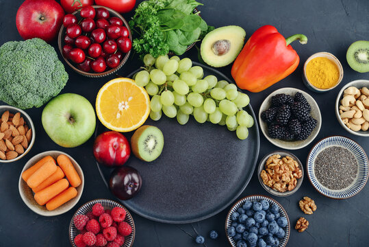 Healthy antioxidant rich foods flat lay on dark background with copy space