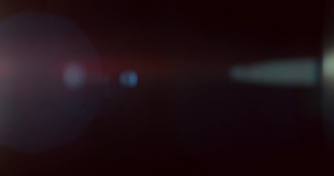 Cinematic moving lens flare overlay in super slow motion featuring glow, soft optical reflections and realistic lens artifacts on a black background. Premium VFX element for compositing.