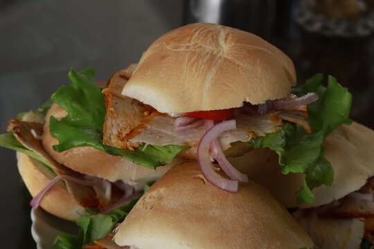 Traditional Peruvian ham sandwich (Butifarra) with pork ham, lettuce, onion and rocoto