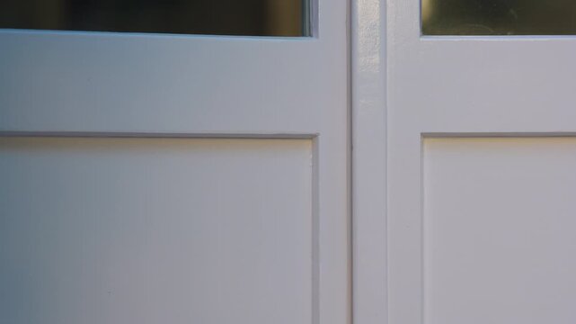 Happy toddler opening and closing door at home, smiling with excitement while greeting loved one, expressing joy, anticipation, playful childhood, family connection