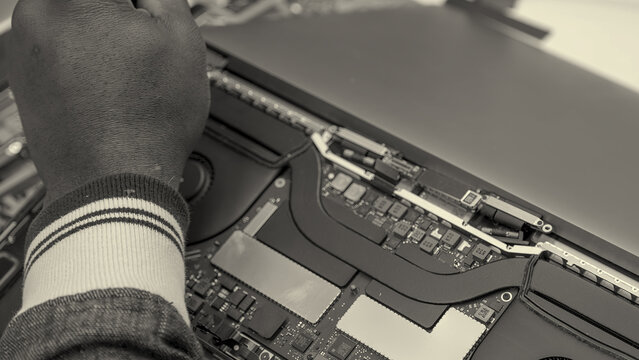 Top-down perspective of open laptop chassis showing circuit board components during repair service