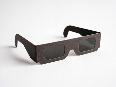 Solar eclipse viewing glasses on white background