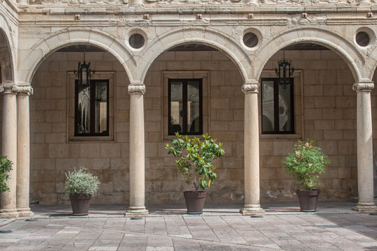 Renaissance semicircular arches with flowerpots in the courtyard of the Guzman Palace in the city of Le&oacute;n, Spain.