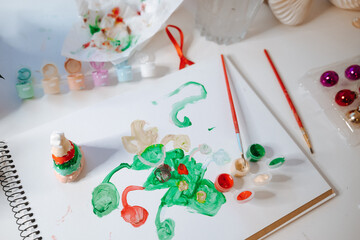 Colorful painting activity with brushes and paint on a table with decorations © Irina Magrelo