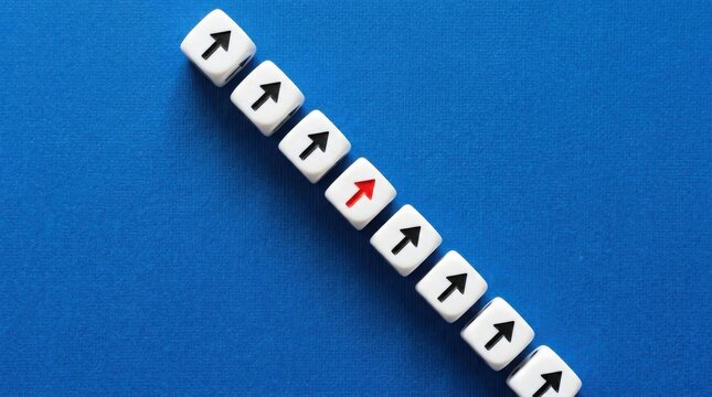 Row of white dice with black arrows pointing up and one red arrow