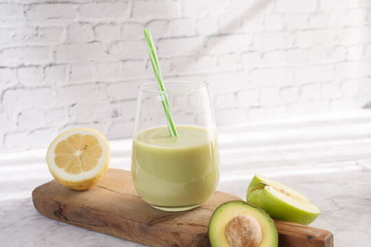 Green smoothie with avocado, lemon, and apple for wellness