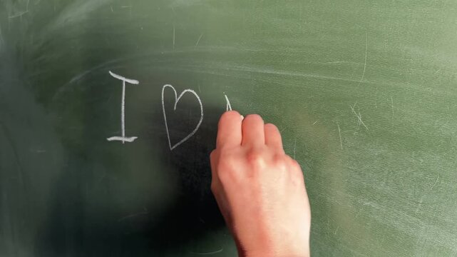 Hand Writing Heart and Love Message on Chalkboard &ndash; Valentine's Day, Romance and Education Concept, 4K Video