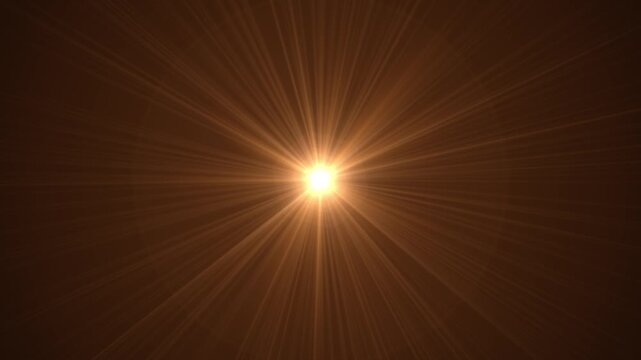 A bright, intense light source radiating a starburst of flare effect against a dark background