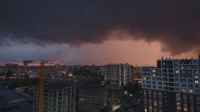 Timelapse of the stormy clouds with rain running over the city.