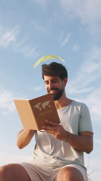 vertical Man dreaming of adventures while reading a travel book