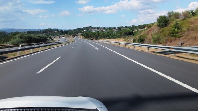 Car driving on the A 52 highway passing road signs in Spain