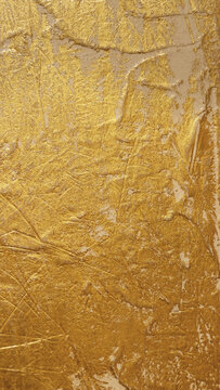 Textured golden stucco background with scratches, scuffs and stains. Plaster backdrop of golden yellow color for copy space.