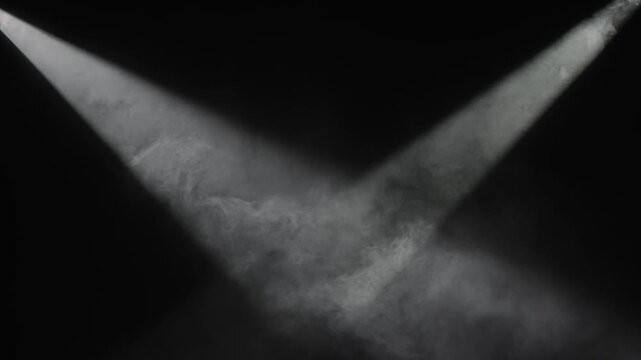 Two white spotlights cross through dense smoke against a black background. Concept stage, theater, concert, cinema, event, advertising, design, and dramatic overlay visual effects.