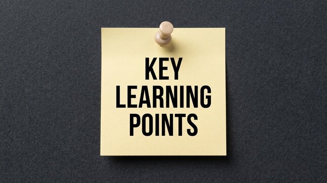Key learning points text on yellow sticky note, educational concept on dark background, business training and development reminder