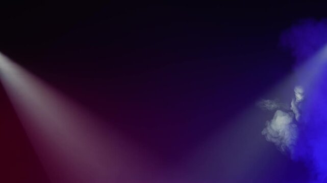 Colored spotlights shine through drifting smoke on a dark stage background. Concept of event, concert, theater, nightlife, overlay, advertising, design, and cinematic visual use.