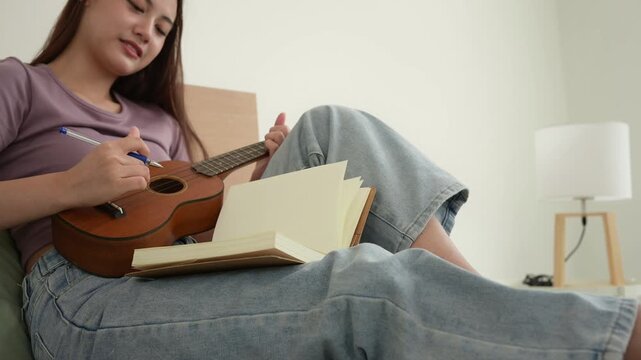 Young Asian Artist Writing Music in Cozy Living Room