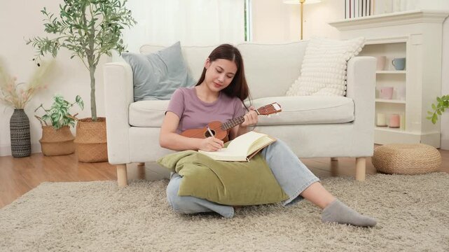Young Asian Artist Writing Music in Cozy Living Room