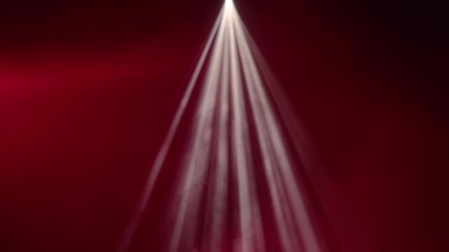 White spotlight beams cut through smoke against a deep red background. Concept concert, theater, event, cinema, advertising, design, and dramatic stage visuals.