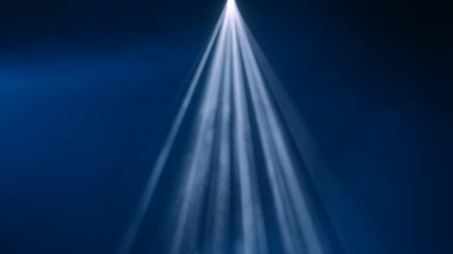 White spotlight beams cut through smoke against a deep blue background. Concept concert, theater, event, cinema, advertising, design, and dramatic stage visuals.