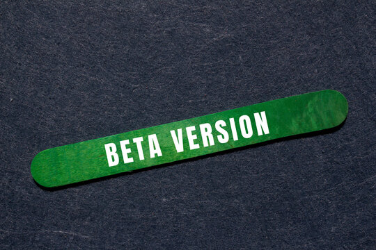 Green wooden stick displaying beta version text, representing software development stages, testing, and trial progress