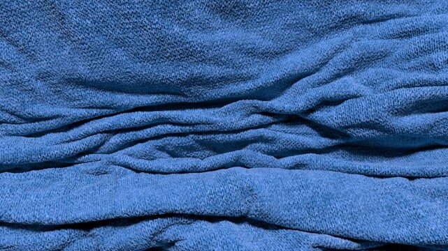 Animated cloth background, slow-motion falling knit fabric gathering and bunching up