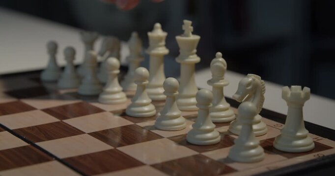 close up of chess piece being moved on board