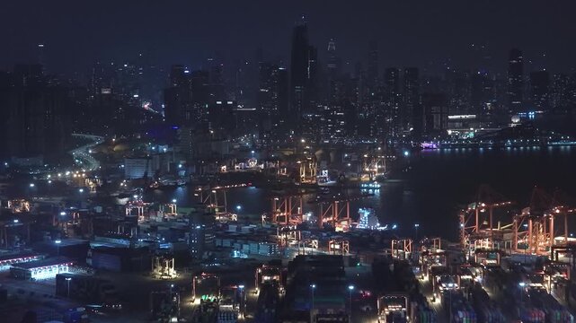 Unloading large cargo containers seaport. Loading freight sea port. Top aerial drone view. Lot big boxes rows, ship delivery ocean harbor. Shipping night. Goods export import. Industrial Marine dock.