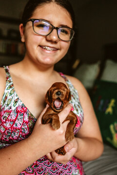 Preteen Girl Cuddling Tiny Puppy
