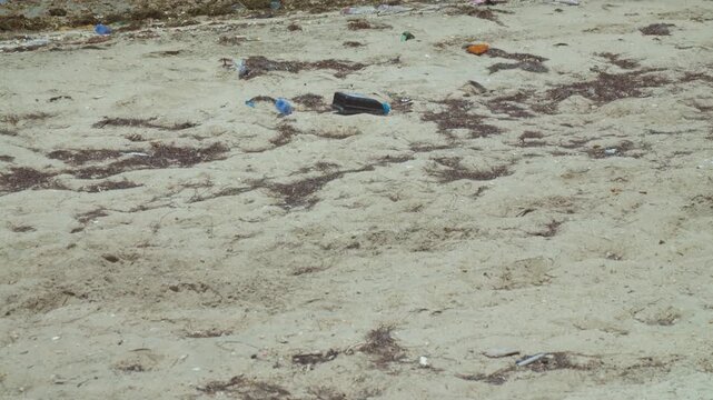 Fishing boats at a dirty beach on a windy day
