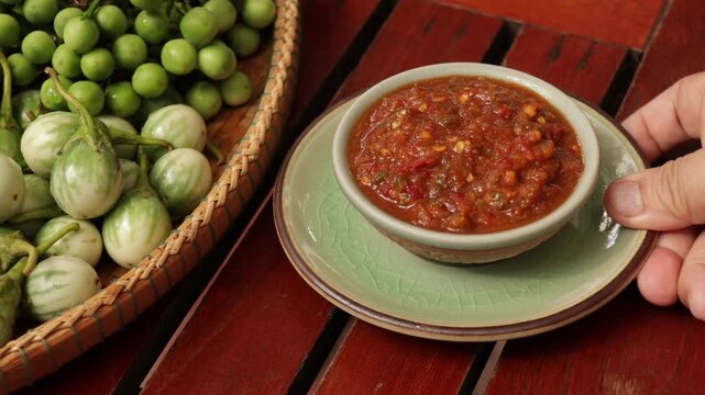 Thai Shrimp Paste Chili Dip (Nam Prik Kapi) with Fresh Vegetables on Wooden Table Thailand.