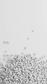 Close-up top view of rotating white polypropylene plastic granules and masterbatch resin pellet pile, 3D render seamless Vertical video.