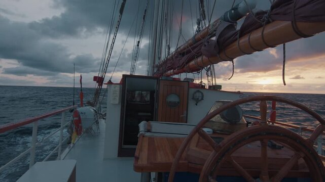 Expeditional sailing vessel moves in the Atlantic Ocean during sunrise