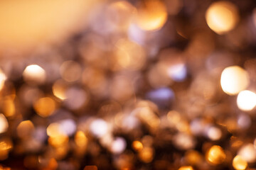 Fototapeta premium Golden glitter particles with soft focus, warm background