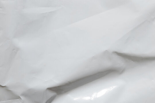White crumpled glossy polyethylene film, packaging material texture for backgrounds, designs