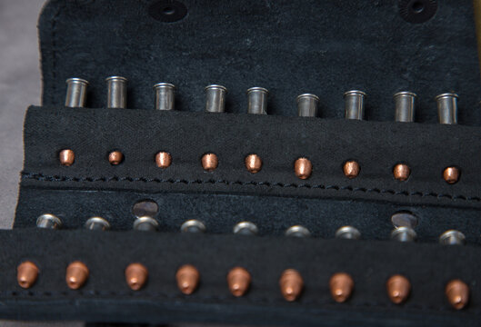 A closeup shot of bullet casings in a black leather case