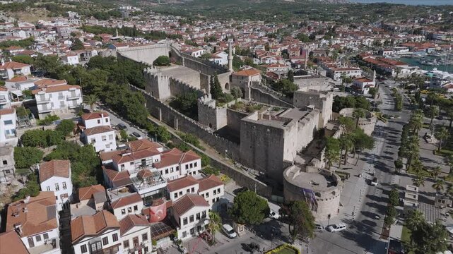 Aerial footage of Cesme Castle, and town centre of Cesme, Turkey. &Ccedil;eşme is a seaside resort town and district on the tip of the Urla-Karaburun-&Ccedil;eşme Peninsula in Turkey's Aegean Region.