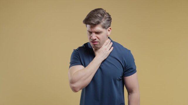 Young adult man Has Sore. Sick Guy Coughs With Swollen Throat On Beige Studio. Pain, ache. Seasonal flu, cold disease