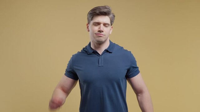 Tired young adult Man Feeling Pain In Neck Joint, Massaging Muscles, Rubbing Head. Guy in polo shirt takes break and kneads sore neck muscles with hand massage.
