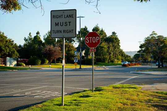 Right lane must turn right at intersection with stop sign