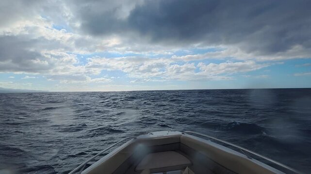First person view from a speedboat riding waves in the open ocean near Mauritius