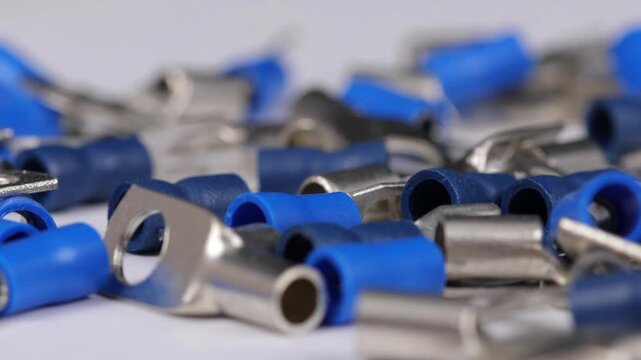 Metal tips with a plastic base for mounting on stranded copper wires. Close-up. Soft focus. Macro.
