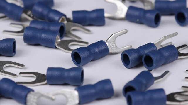Metal tips with a plastic base for mounting on stranded copper wires. Close-up. Soft focus. Macro.